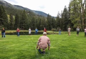 Instructor holding fishermans lines at Mountain Sky property, teaching them fly fishing basics