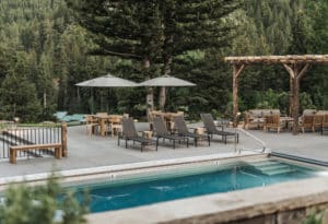 Outdoor pool & patio with seating at Mountain Sky Guest Ranch