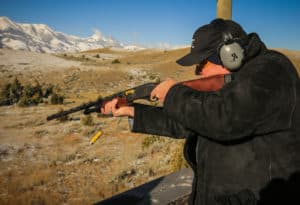 Man shooting a shotgun at Mountain Sky's clay shooting range