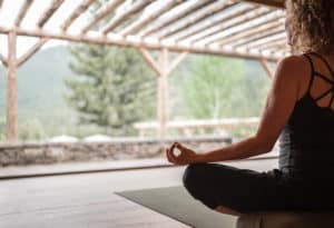 Woman doing yoga looking at view at Mountain Sky Guest Ranch