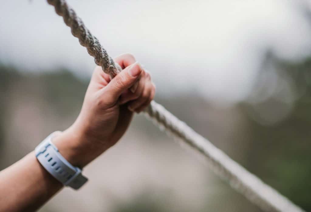 Persons hand grabbing a rope at Mountain Sky Guest Ranch challenge course