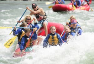 Laughing guests in raft on the Yellowstone River