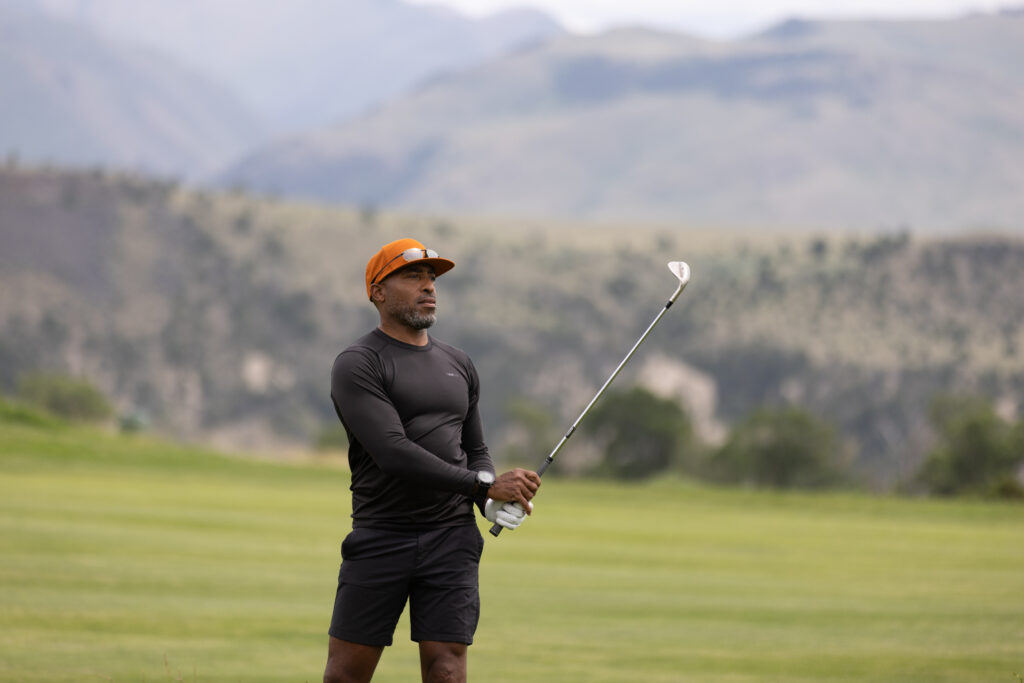 A golfer prepares to take his shot at Rising Sun Golf Course at Mountain Sky Dude Ranch