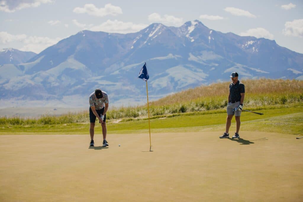 Two golfers enjoy the green at Rising Sun Golf Course at Mountain Sky Ranch.